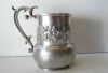 VECHE CANA PENTRU VIN SAU BERE - METAL ARGINTAT CU ORNAMENTE EXECUTATE MANUAL SI MANER TURNAT